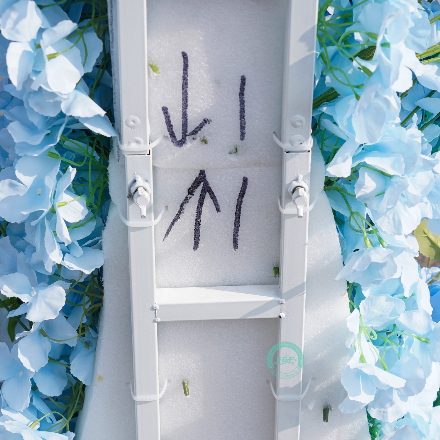White horn wedding arch with blue flowers