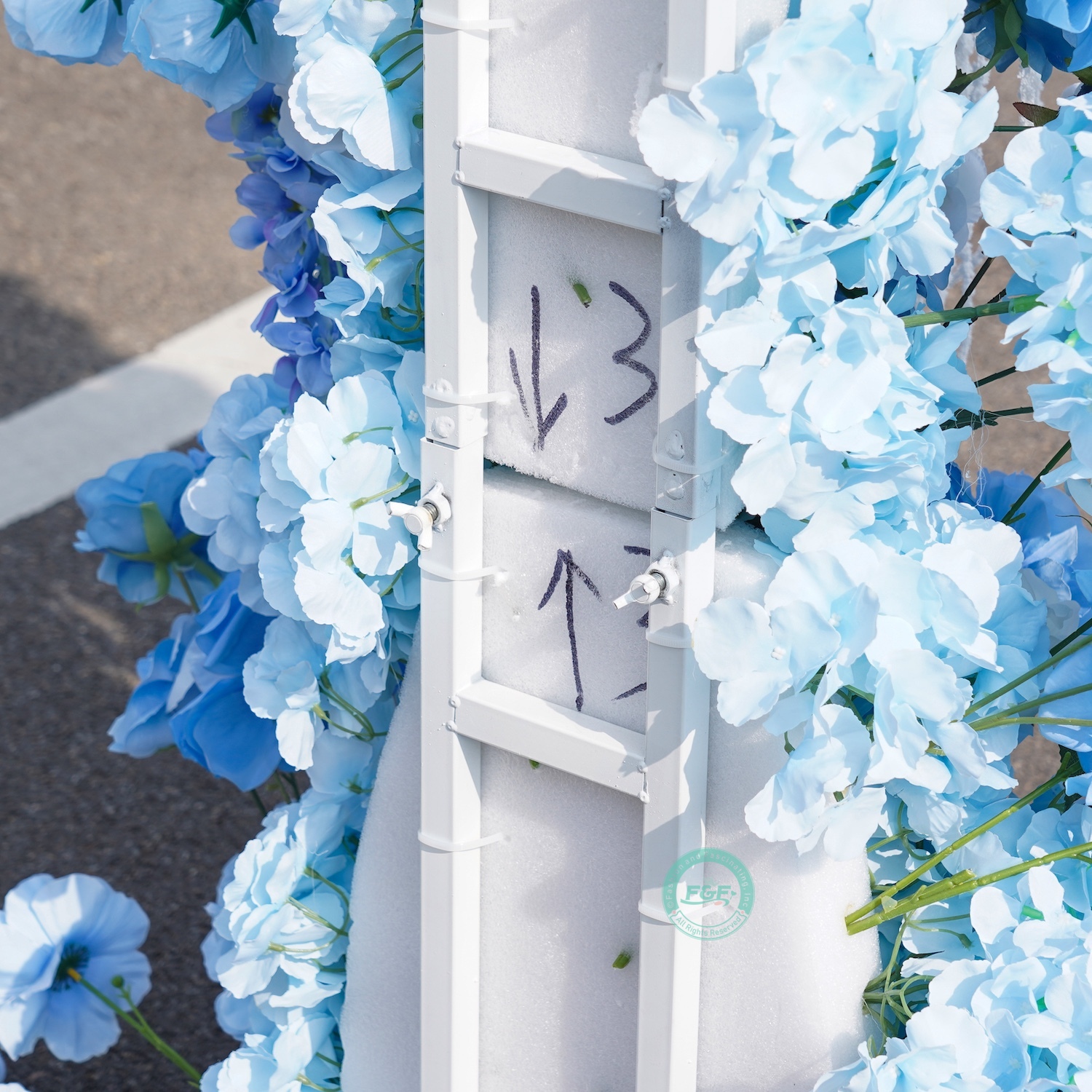 White horn wedding arch with blue flowers