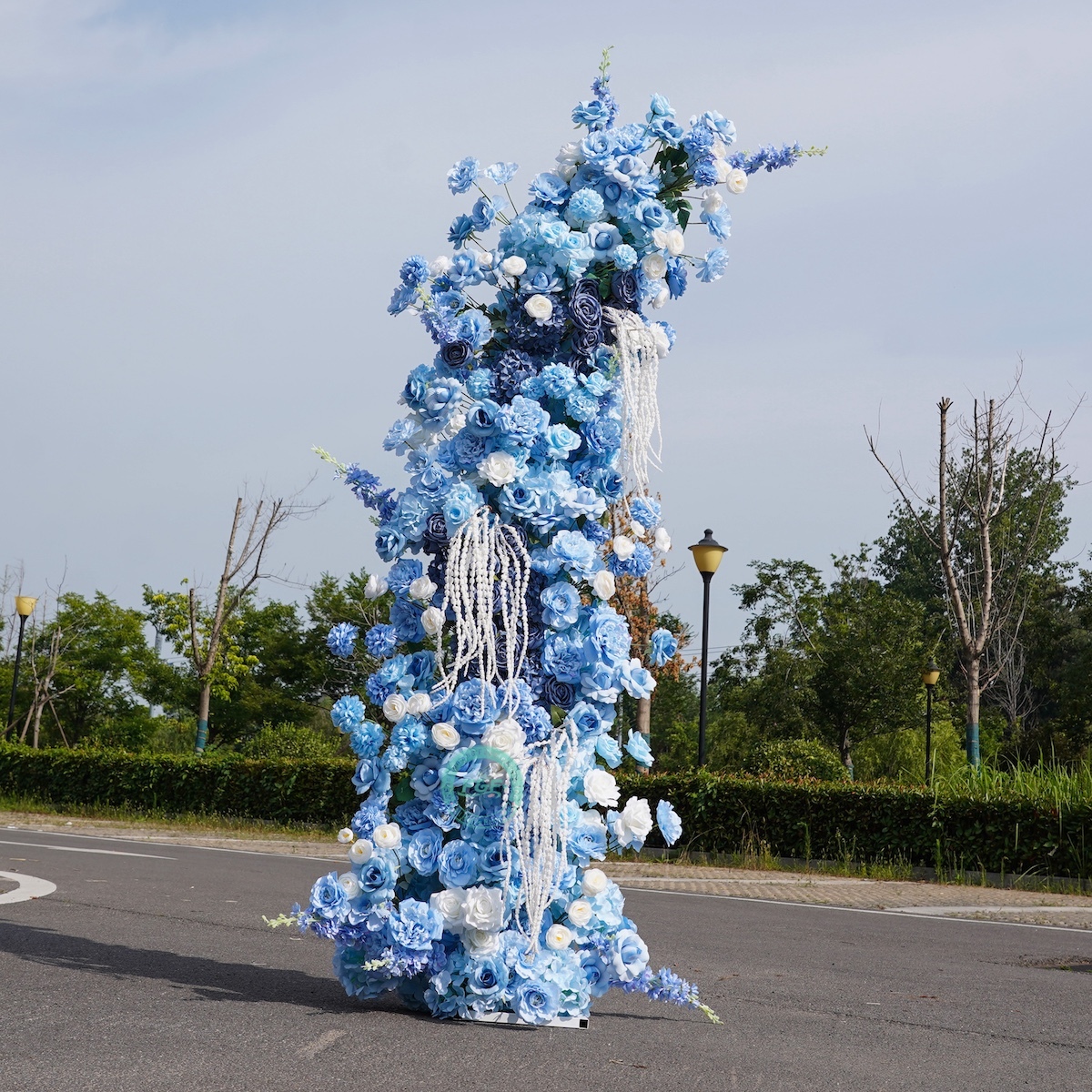 White horn wedding arch with blue flowers