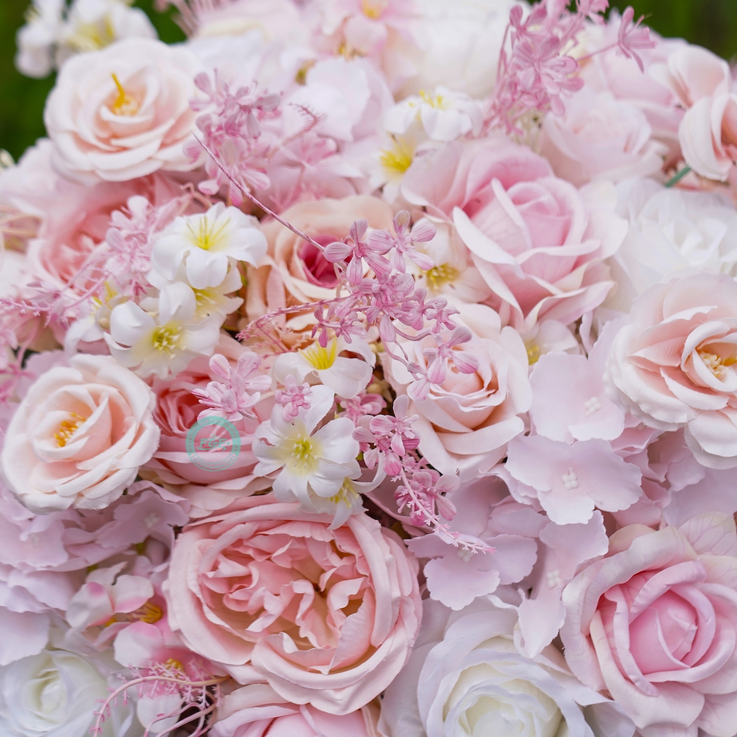 Close-up of an elegant pink and white artificial rose flower ball centerpiece for wedding table decor.